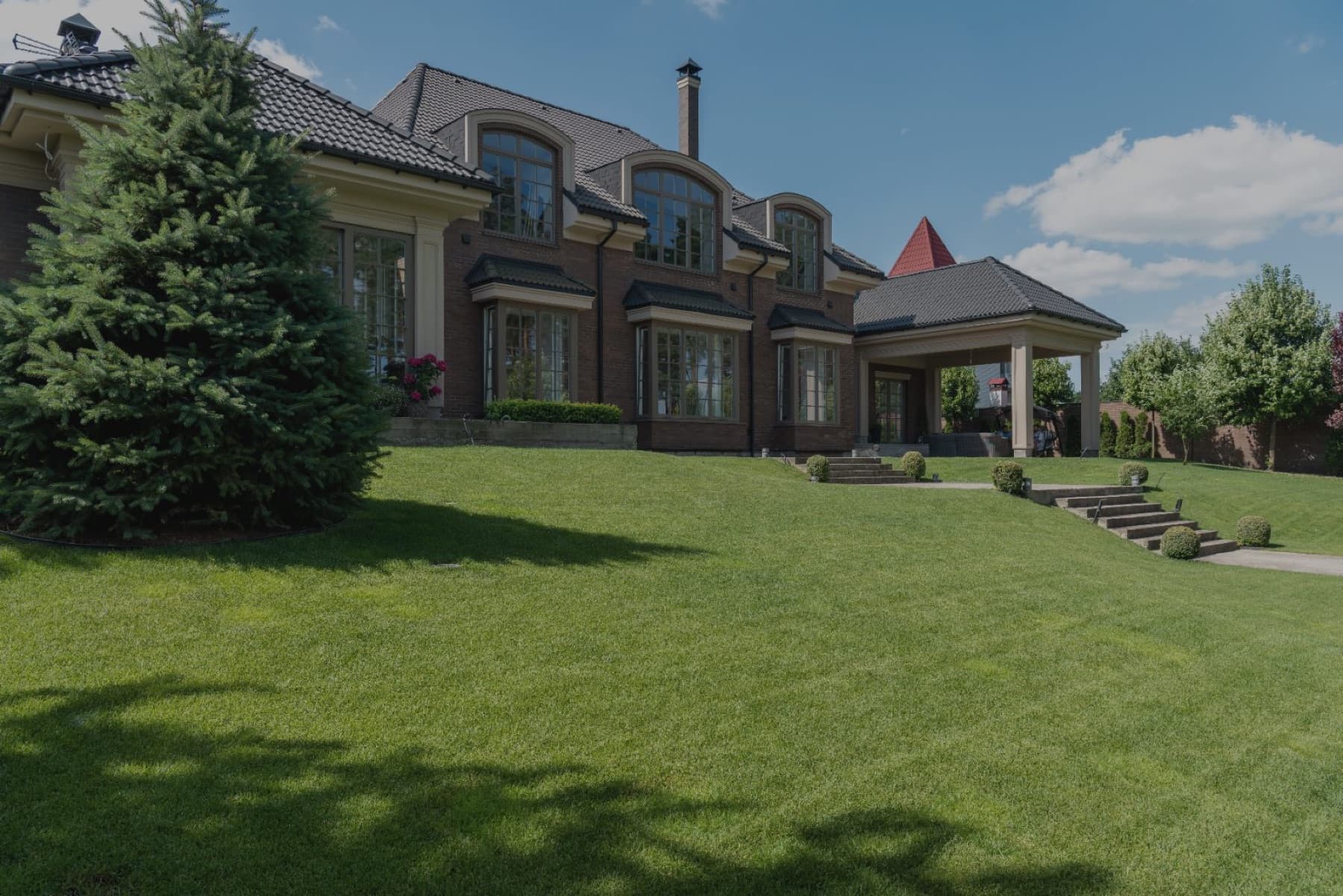 A finished home exterior with a freshly landscaped front yard
